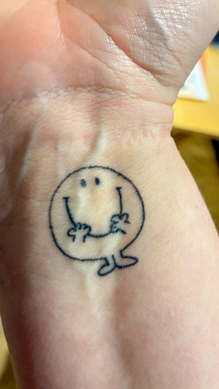 A second pin badge tattoo, matching the first.